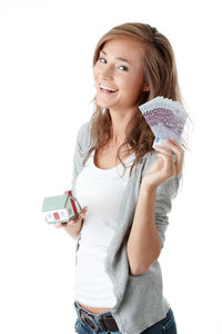 Portrait of a smiling young woman against white background