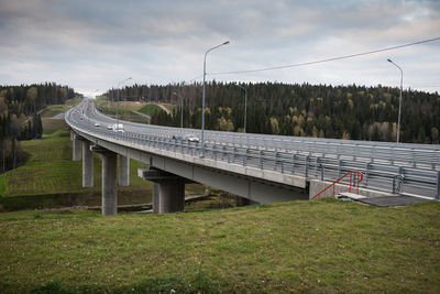 Bridge over field against sky