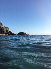 Scenic view of sea against clear blue sky