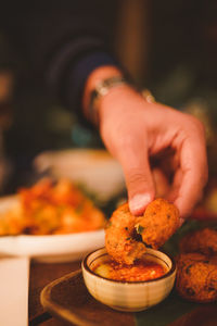 Cropped hand of man preparing food