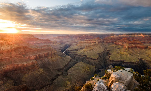 Scenic view of dramatic landscape against sky during sunset