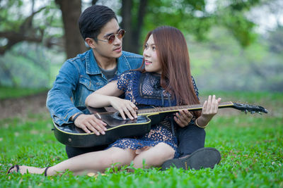 Young couple sitting outdoors