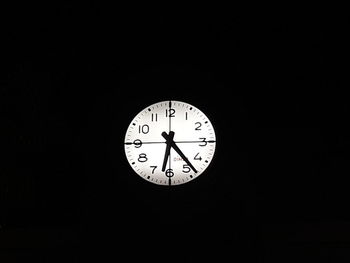 Low angle view of clock in darkroom