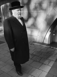 Young man standing on footpath