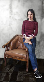 Portrait of young woman sitting on seat