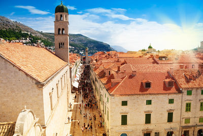 High angle view of old buildings in town against sky