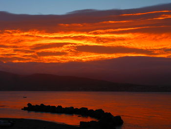 Scenic view of sea against romantic sky at sunset