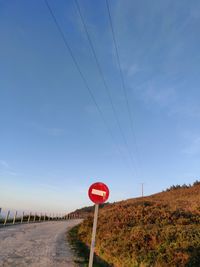 Road sign against clear sky