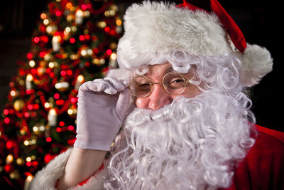 Close-up portrait of man wearing santa claus costume at home
