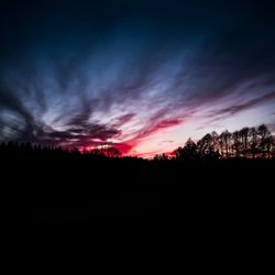 Silhouette landscape against sky at sunset