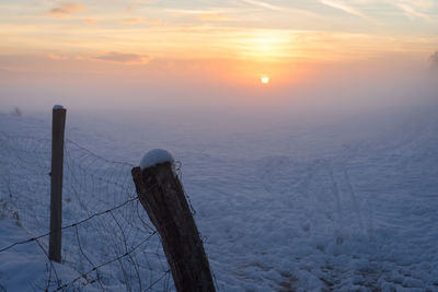 Scenic view of sunset against sky during winter