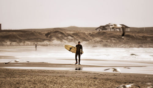 Rear view of man standing on beach