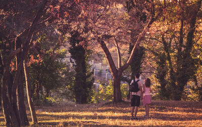 Rear view of people walking in park