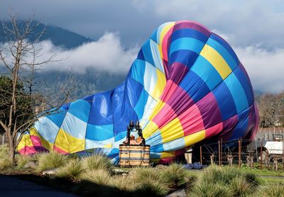 Multi colored hot air balloon against sky