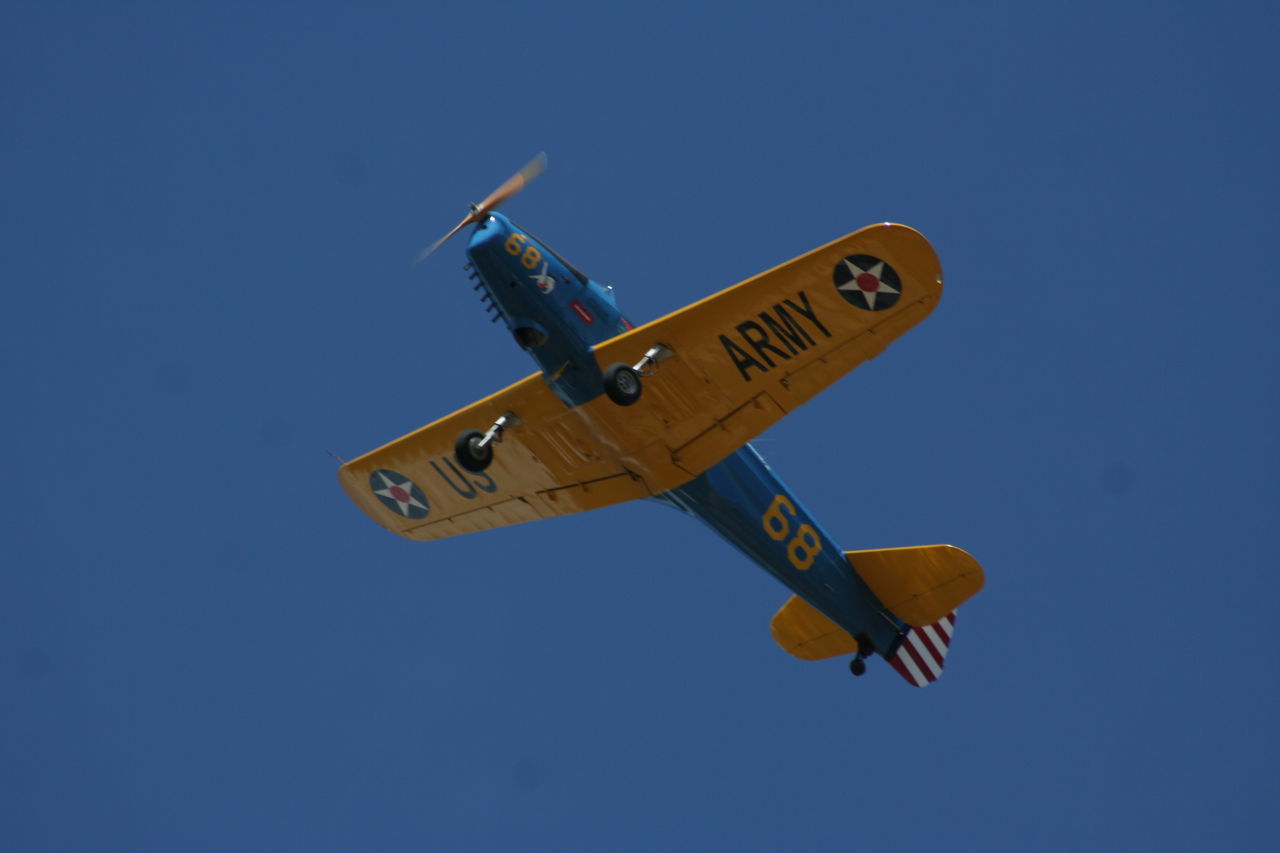 flying, low angle view, transportation, clear sky, mode of transport, air vehicle, airplane, journey, no people, outdoors, public transportation, motion, day, sky