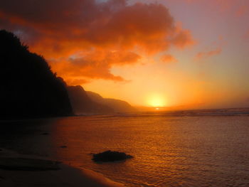 Scenic view of sea against orange sky