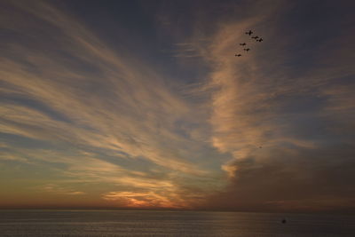 Scenic view of sea against orange sky