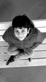 Portrait of boy sitting outdoors