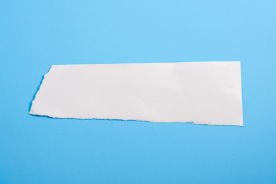Close-up of white paper against blue background