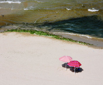 High angle view of pink umbrella on beach