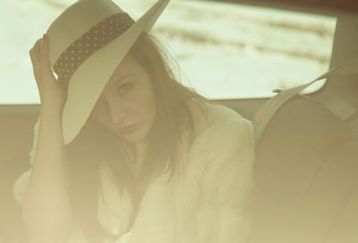 Portrait of young woman in hat