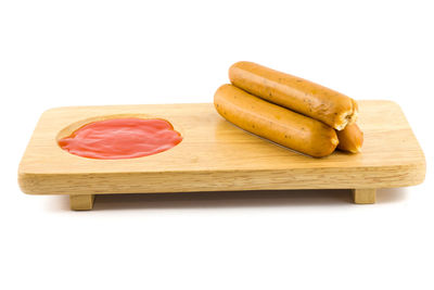 High angle view of bread on cutting board against white background