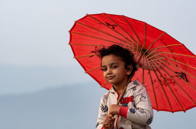 Young woman holding umbrella