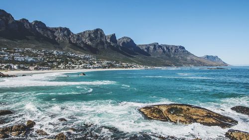 Scenic view of sea and mountains against sky