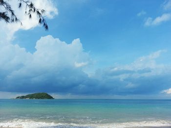 Scenic view of calm sea against cloudy sky