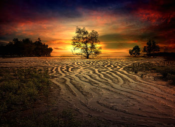 Scenic view of land against sky during sunset