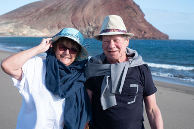 Portrait of senior couple standing at beach