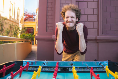 Portrait of a smiling young man standing outdoors