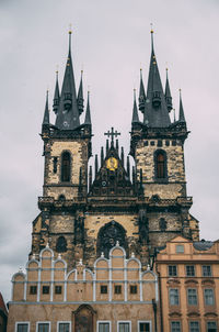 Low angle view of church against cloudy sky