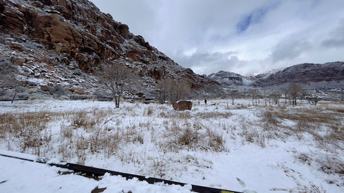 Scenic view of snow covered field against sky