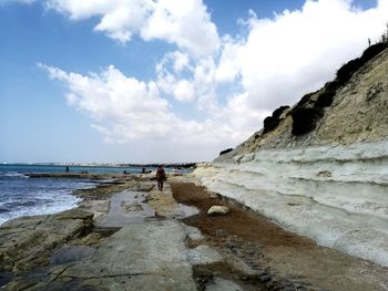 Man standing on beach against sky