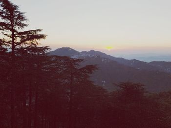 Scenic view of silhouette mountains against sky at sunset