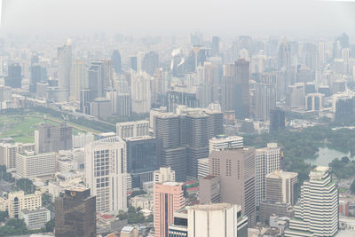 Aerial view of buildings in city against sky