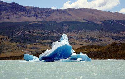 Scenic view of iceberg floating in water