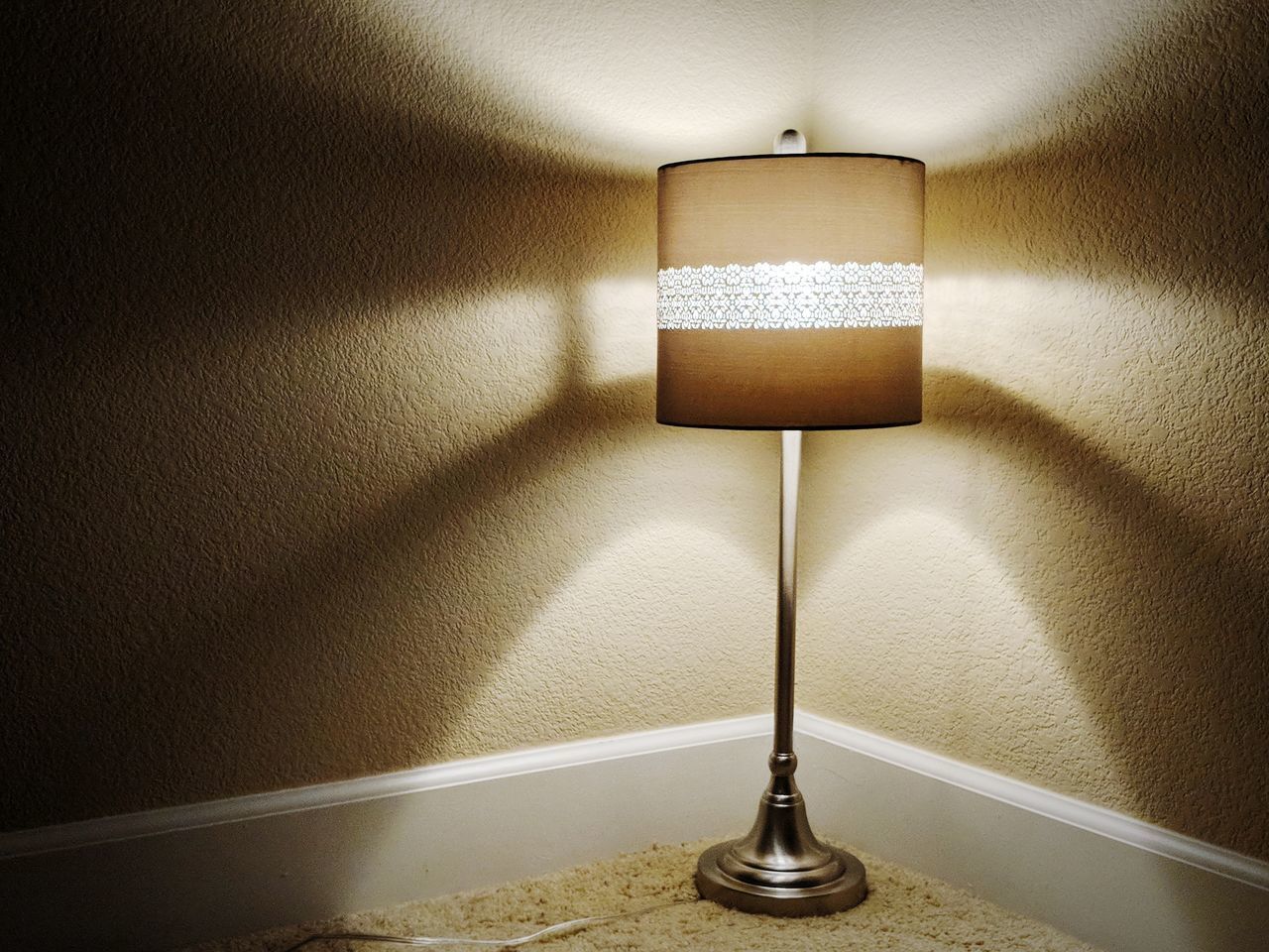 CLOSE-UP OF ILLUMINATED LAMP AT HOME