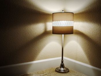 Close-up of illuminated lamp on wall at home