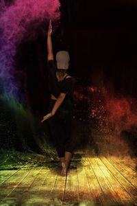 Blurred motion of woman dancing at night