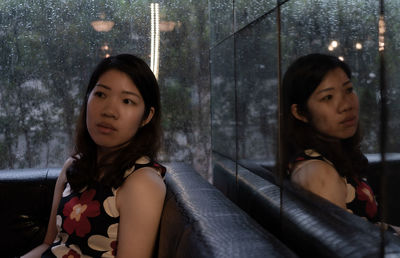 Woman looking way while sitting at cafe