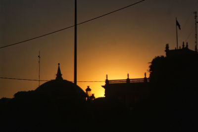 Silhouette of building against sky during sunset