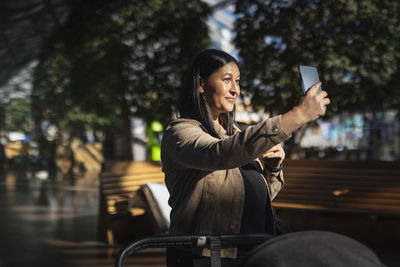 View of smiling mid adult woman talking selfie