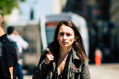 Portrait of beautiful young woman in city