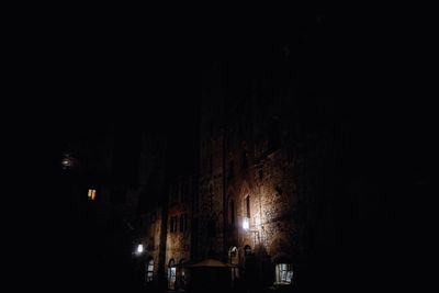 Low angle view of illuminated street light in city at night