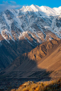 Aerial view of snowcapped mountains against sky