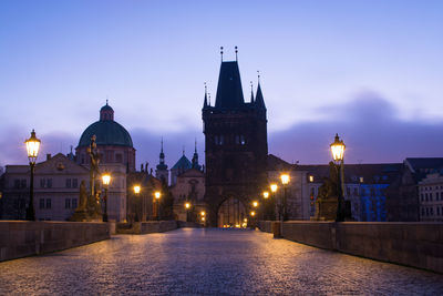 Prague's charles bridge against sky at dusk