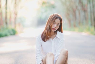 Portrait of young woman sitting outdoors