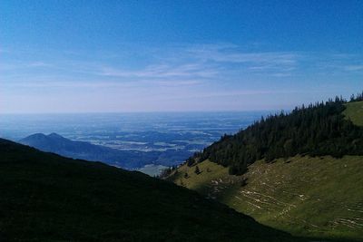 Scenic view of landscape against blue sky